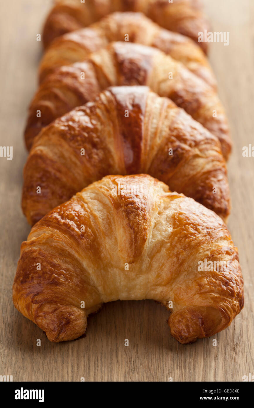 Row of fresh baked french croissants Stock Photo