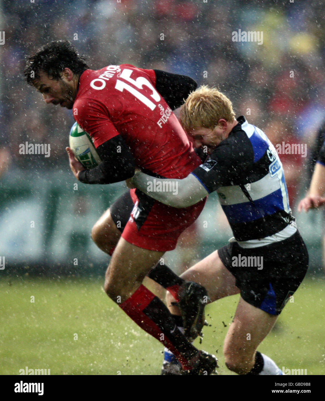 Rugby Union - Heineken Cup - Pool Five - Bath Rugby v Toulouse - The Recreation Ground. Toulouse's Clement Poitrenaud is tackled by Bath's Alex Crockett during the Heineken Cup match at The Recreation Ground, Bath. Stock Photo