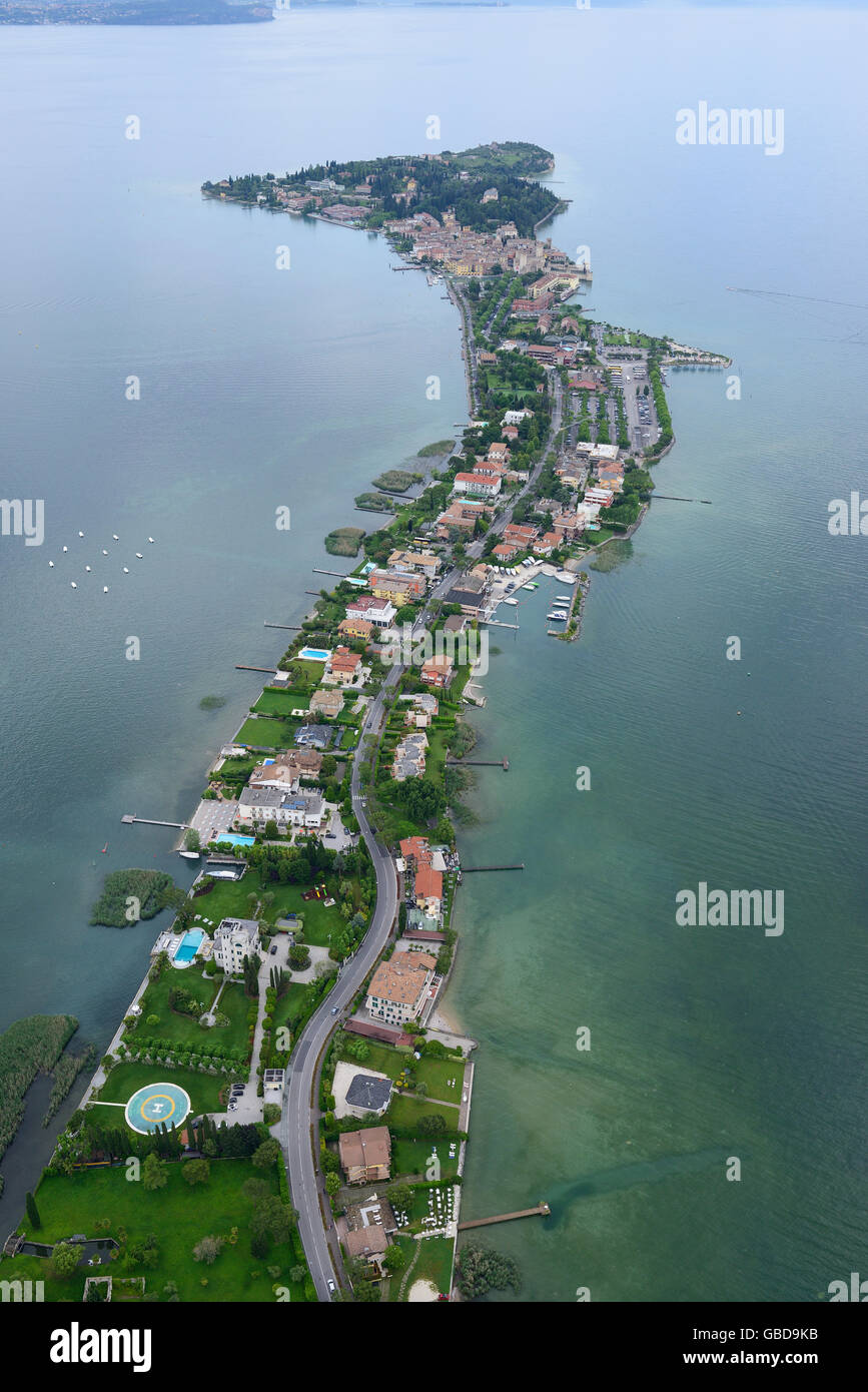 AERIAL VIEW. Surprisingly long and narrow peninsula on the southern shore of Lake Garda. Sirmione, Province of Brescia, Lombardy, Italy. Stock Photo
