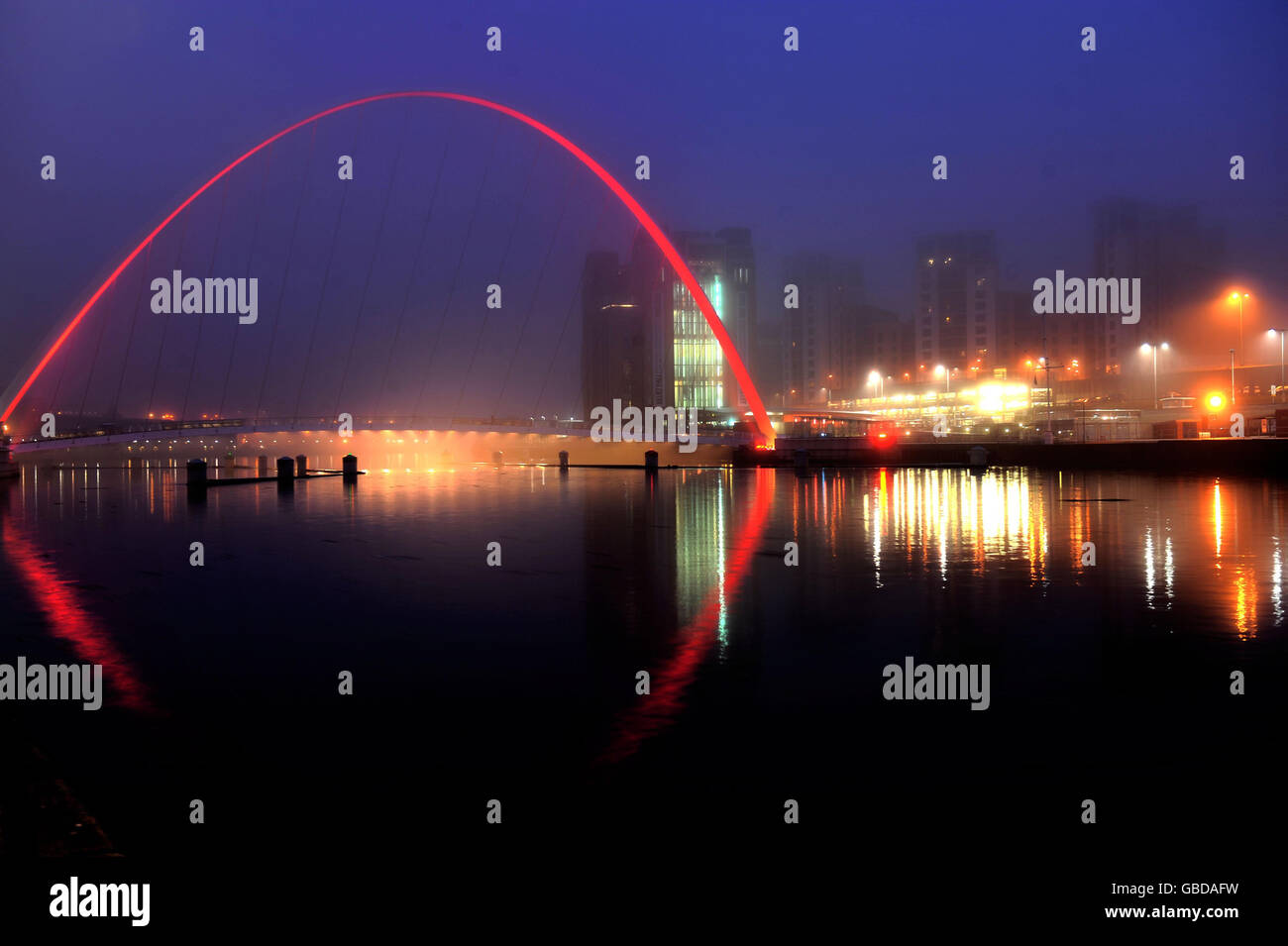 Fog Rolls Over The Millennium Bridge In Newcastle Which Has Been Lit Up Red For Comic Relief To Mark The Launch Of This Year S Red Nose Day Stock Photo Alamy