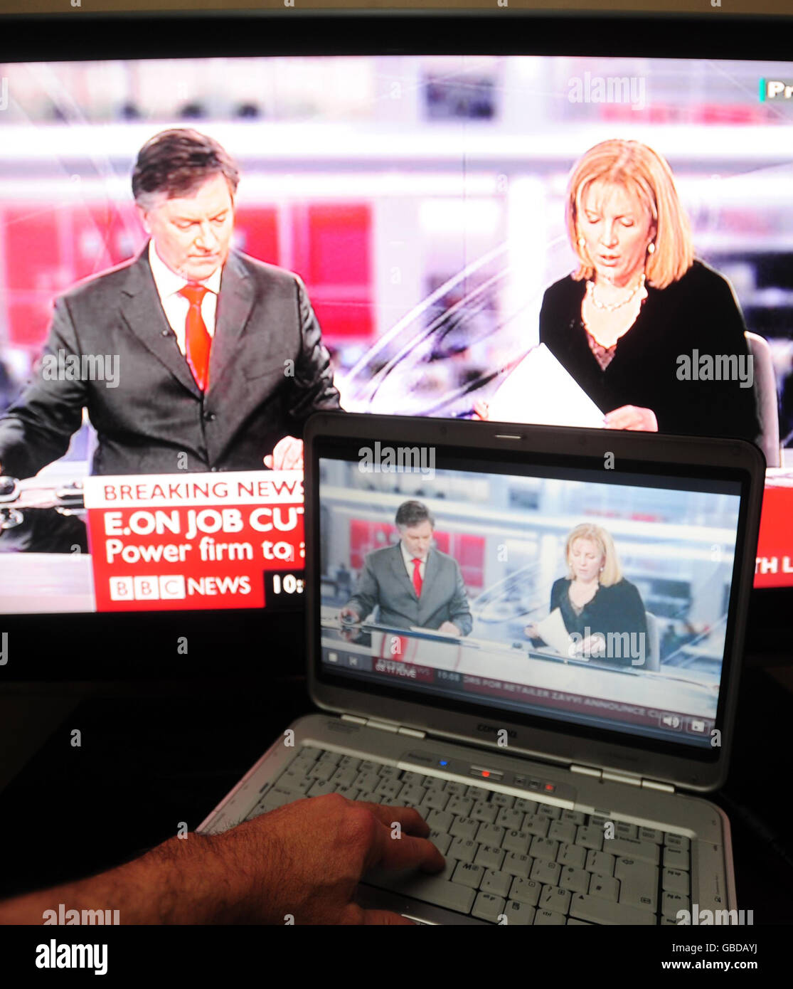 BBC News is viewed on the screens of a laptop computer and a television. Broadband users could end up paying for a new body to tackle music and film piracy under Government plans to be announced today. Stock Photo