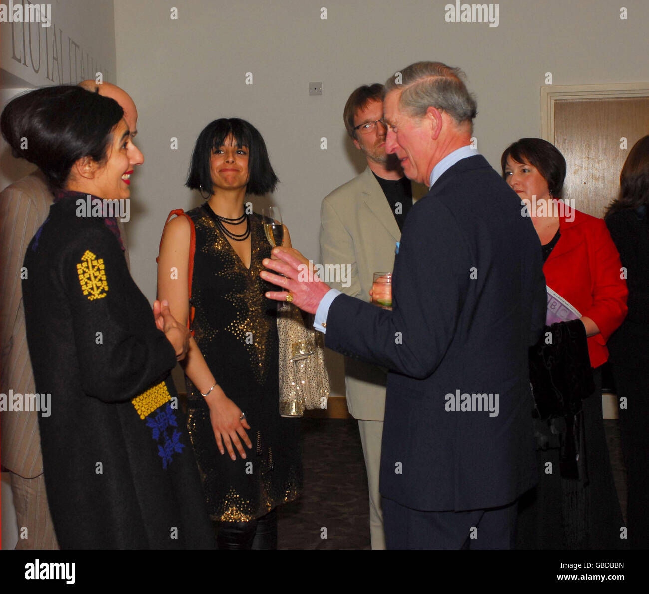 The Prince of Wales (centre right) speaks to artist Lubna Chowdary (left) who designed a piece of memorial artwork entitled Nocturne, which was unveiled during the Prince of Wales' visit to BBC National Orchestra of Wales' new home, the purpose-built Hoddinott Hall in the Wales Millennium Centre (WMC), Cardiff Bay. Stock Photo