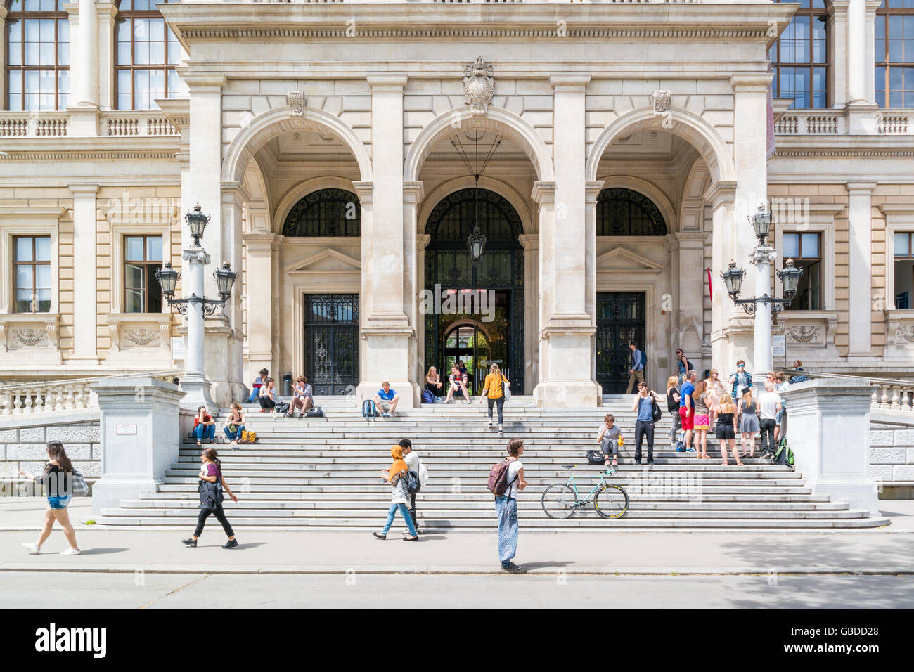 People at entrance of main building of University on Ringstrasse in inner city of Vienna, Austria Stock Photo