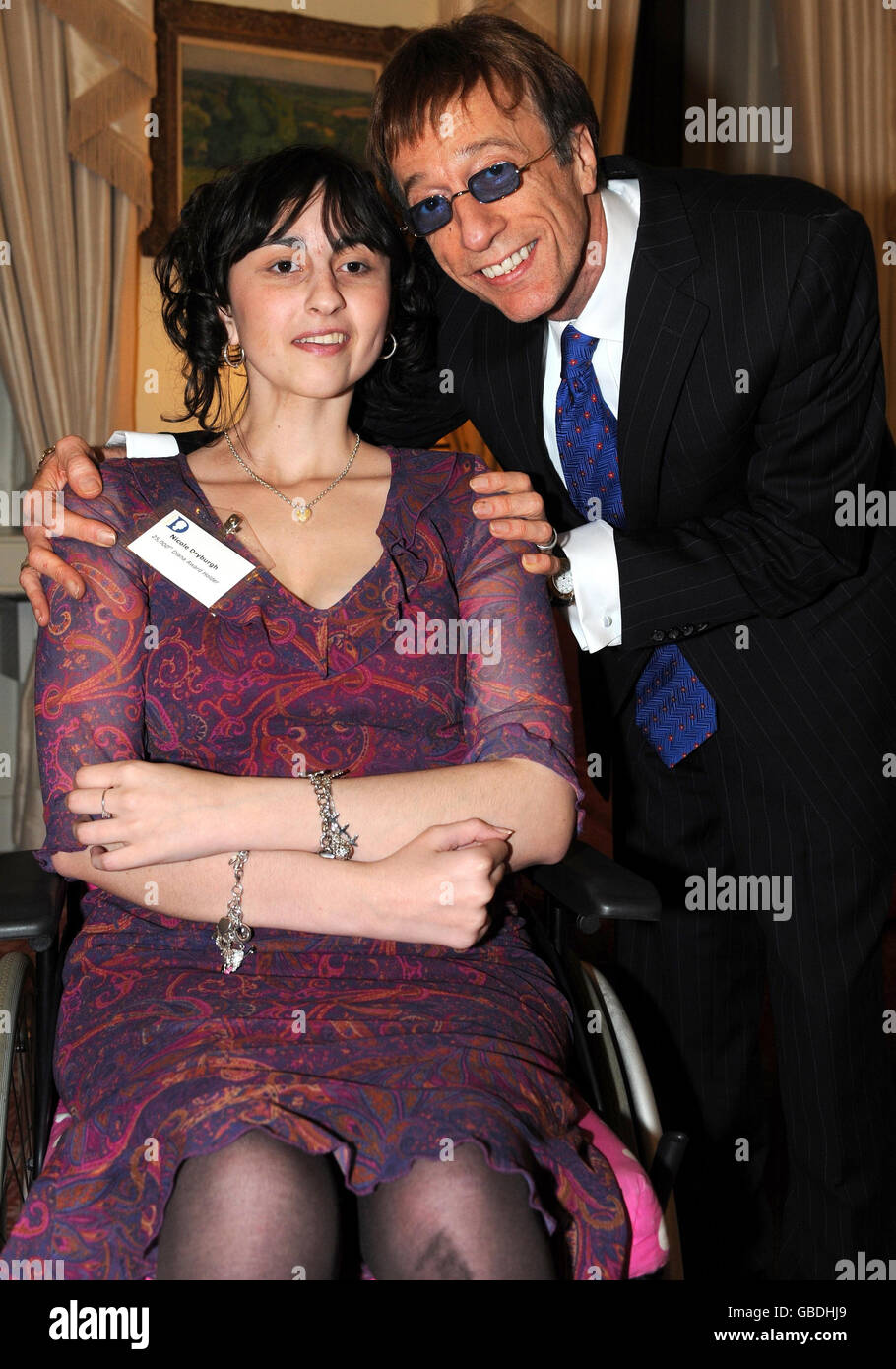 Bee Gee Robin Gibb, 59, with Diana Award winner Nicole Drysburgh, 19, attending a reception for Diana Award winners at 11 Downing Street. Stock Photo