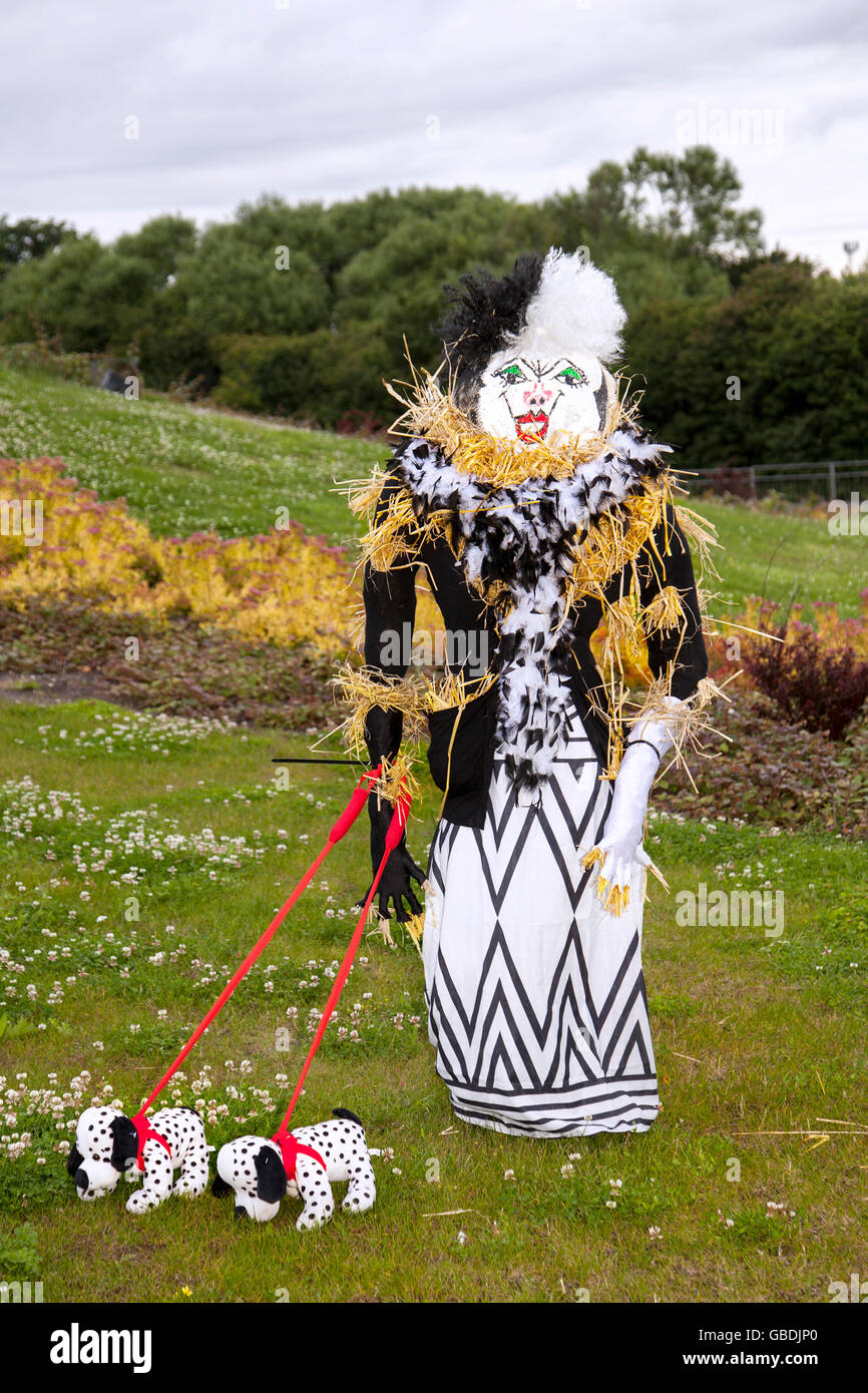 Evil 'Cruella De Vil' stuffed Evil Witch Evil Queen Maleficent. Caricature figure and her Dalmatian dogs at the Wray Scarecrow Festival established 1995, takes place every year, with a different theme. Stock Photo