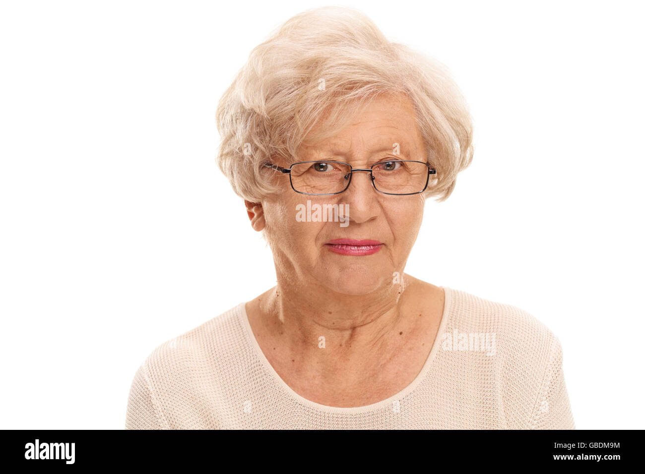 Close-up studio shot of an elderly lady with glasses isolated on white background Stock Photo