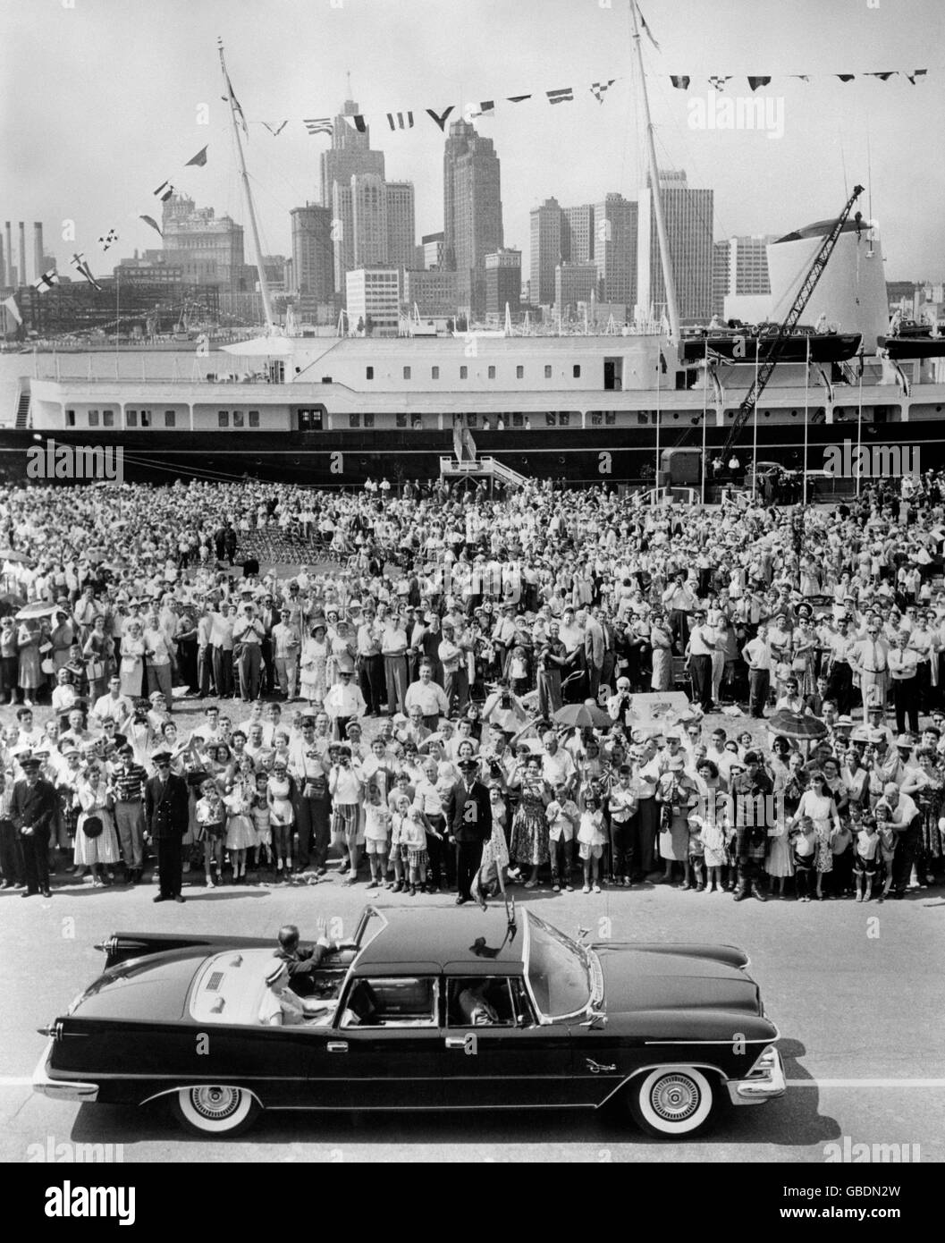 Queen Elizabeth II, the Duke of Edinburgh, cheering Canadians and Americans, Royal Yacht 'Britannia' and the famous American skyline of Detroit, Michigan, are all seen in this impressive picture of the Royal Tour of Canada. Stock Photo
