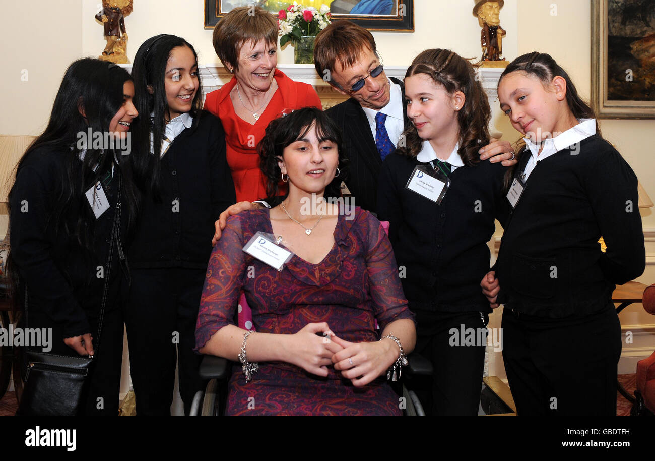 Bee Gee Robin Gibb, 59, attending a reception for Diana Award winners at 11 Downing Street with head of the charity Maggie Turner (third left, back) winners Nicole Drysburgh, 19, author and fundraiser (seated) and Yeading Junior School students, recognised for their work in peer mediation (left to right) Baljoyt Mangat, Simran Johal, Lorita Krsniqi and Yasmin Dummett. Stock Photo
