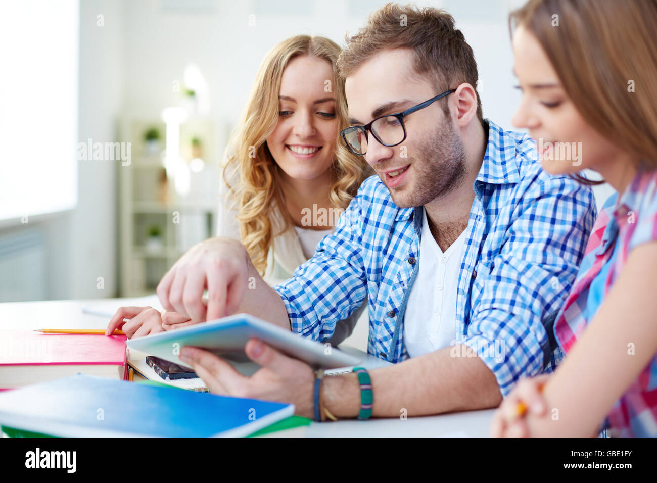 Contemporary teens networking in college Stock Photo