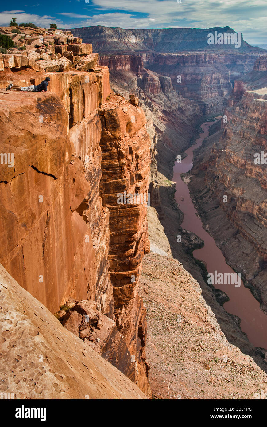 Young man looking at Grand Canyon from Toroweap Point at North Rim, 1000 meters above Colorado River, Arizona, USA Stock Photo
