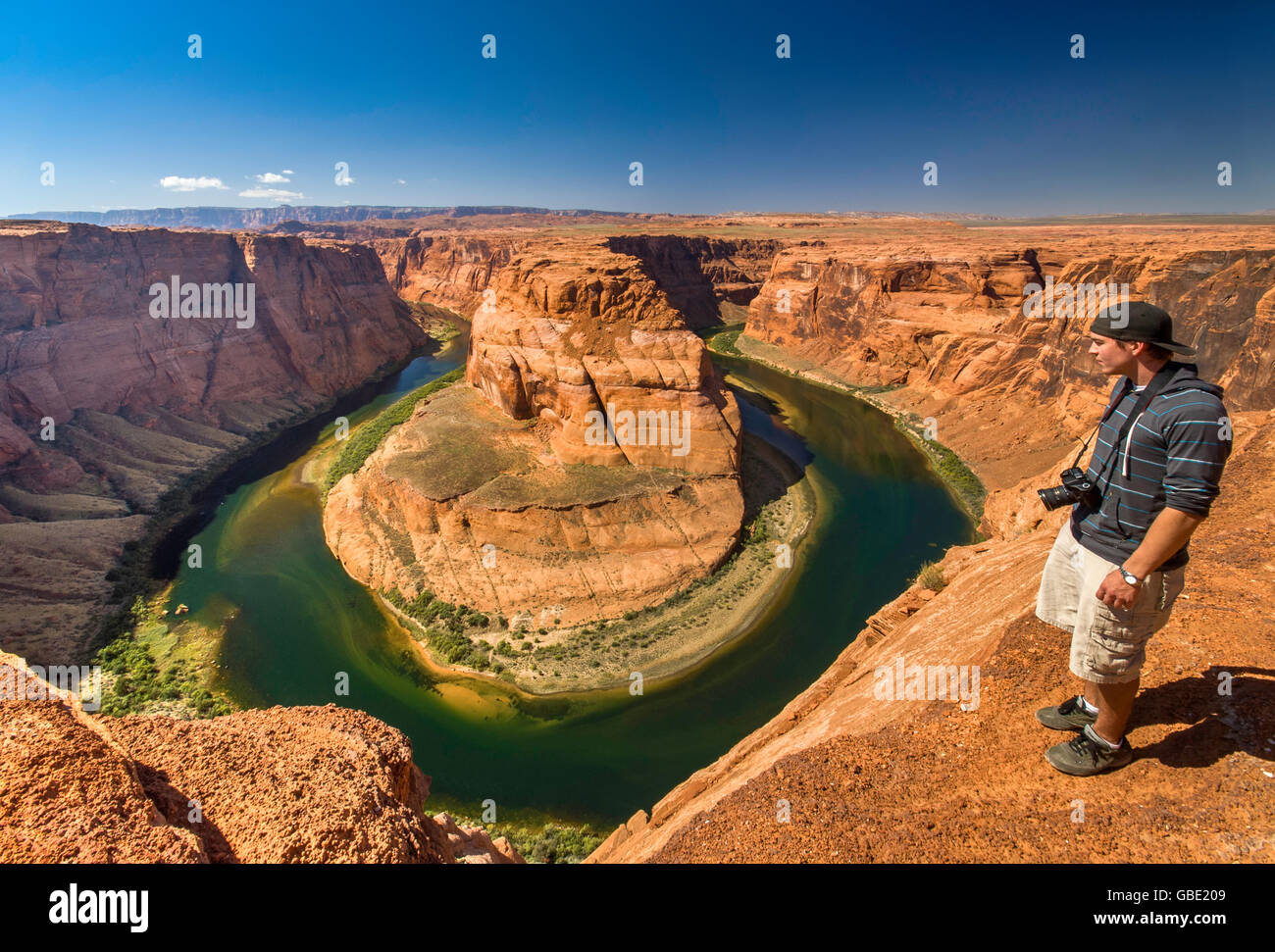 Young man looking at Horseshoe Bend of Colorado River near Page, Arizona, USA Stock Photo