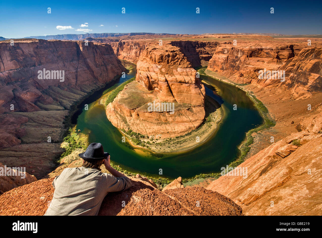 Young man in a fedora looking at Horseshoe Bend of Colorado River near Page, Arizona, USA Stock Photo