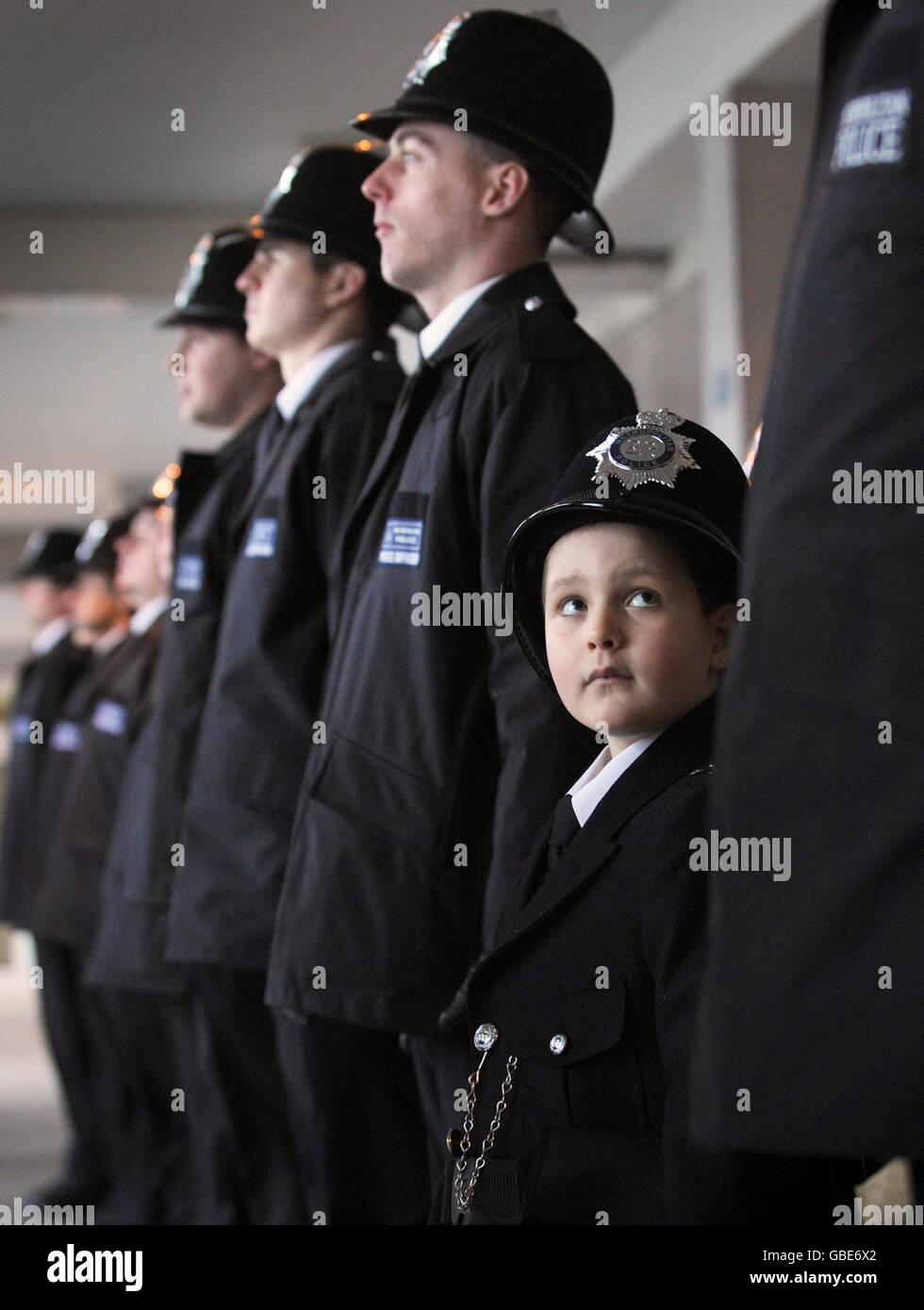 Six year-old Oscar (bottom right) from north London joins a police parade at Hendon Police training college. Stock Photo