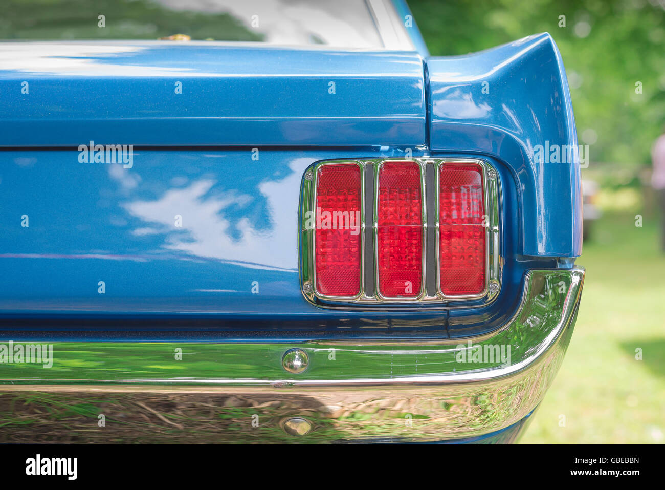 Detail of the rear wing and and tail light cluster of a 1965 Ford Mustang Coupe car. Stock Photo