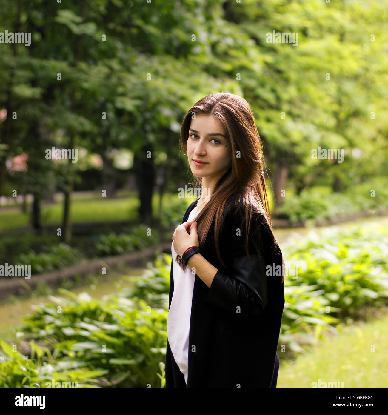 charming young girl walking in the park Stock Photo - Alamy