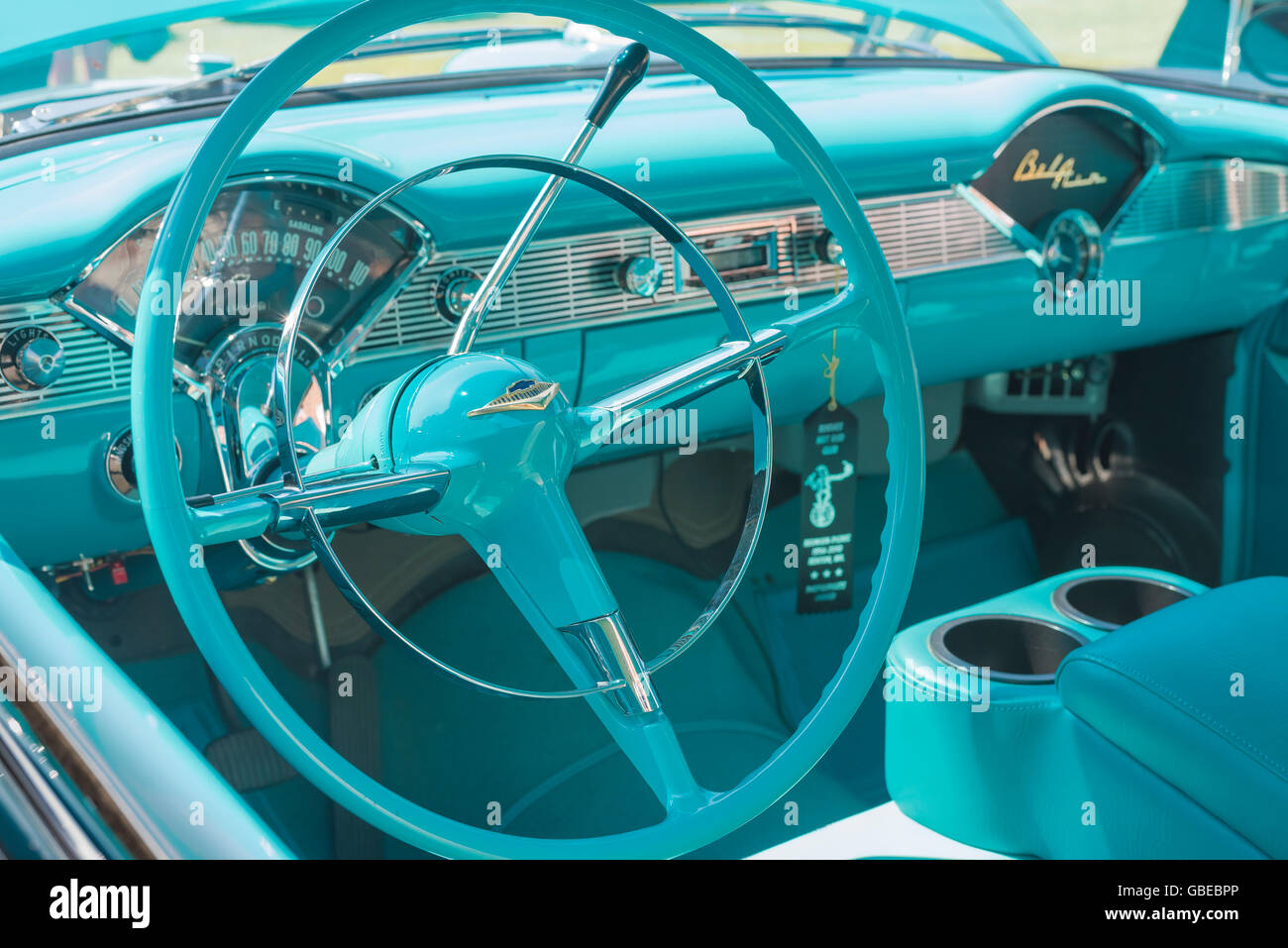 Steering wheel and instrument panel of a turquoise 1957 Chevrolet Bel Air car. Stock Photo