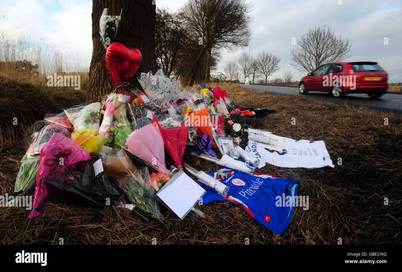 Floral tributes at the scene on the A614 Old Rufford Road near Bilsthorpe, Nottinghamshire where six people died on Friday night after becoming trapped in a fireball after a head-on car crash. Stock Photo