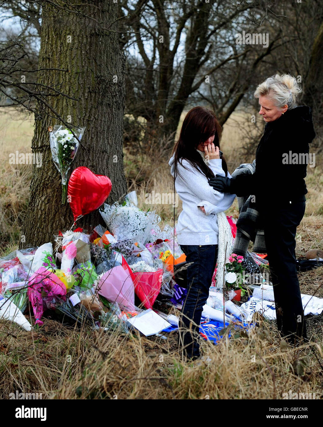 People view floral tributes at the scene on the A614 Old Rufford Road near Bilsthorpe, Nottinghamshire where six people died on Friday night after becoming trapped in a fireball after a head-on car crash. Stock Photo