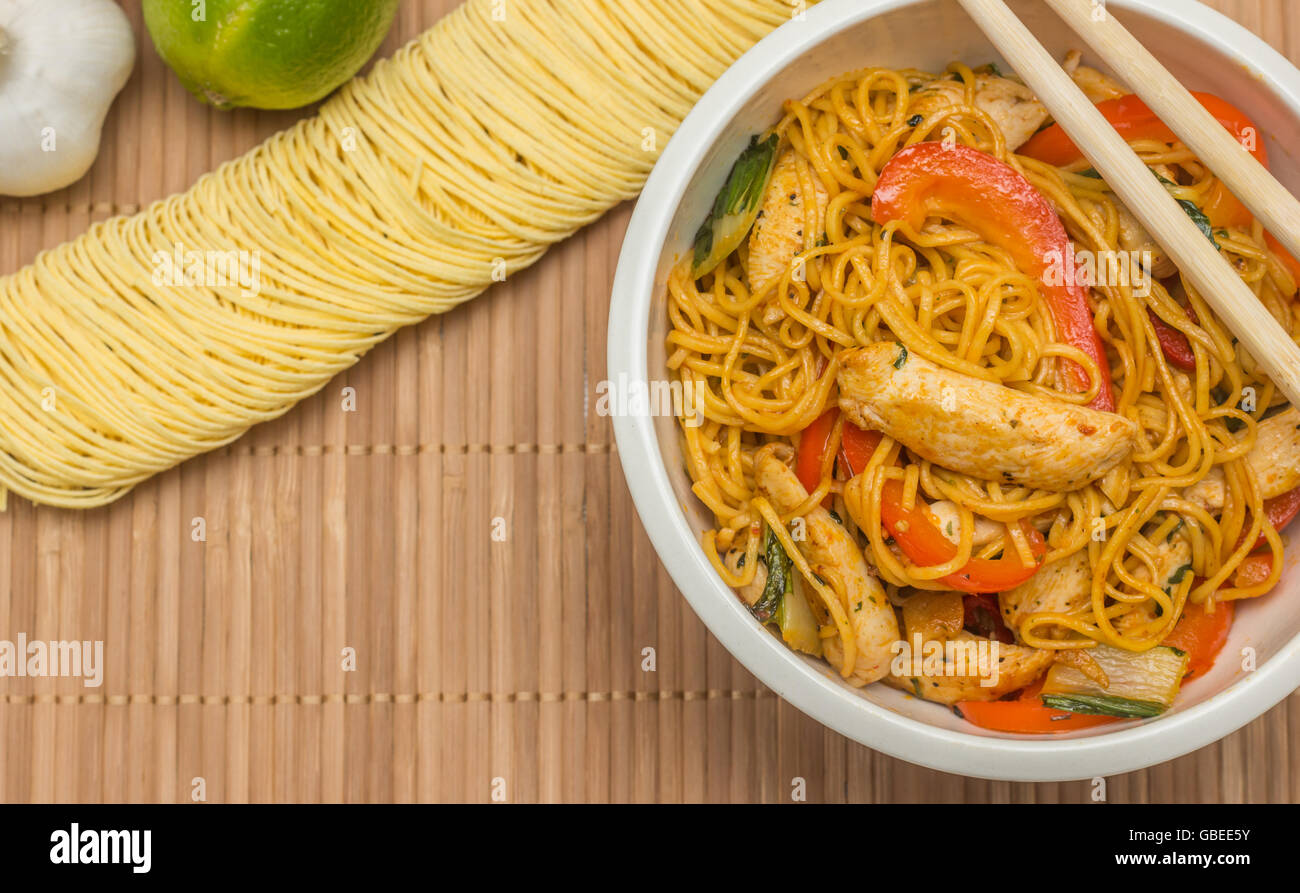 Chinese chow mein with chicken, red peppers and bok choy Stock Photo