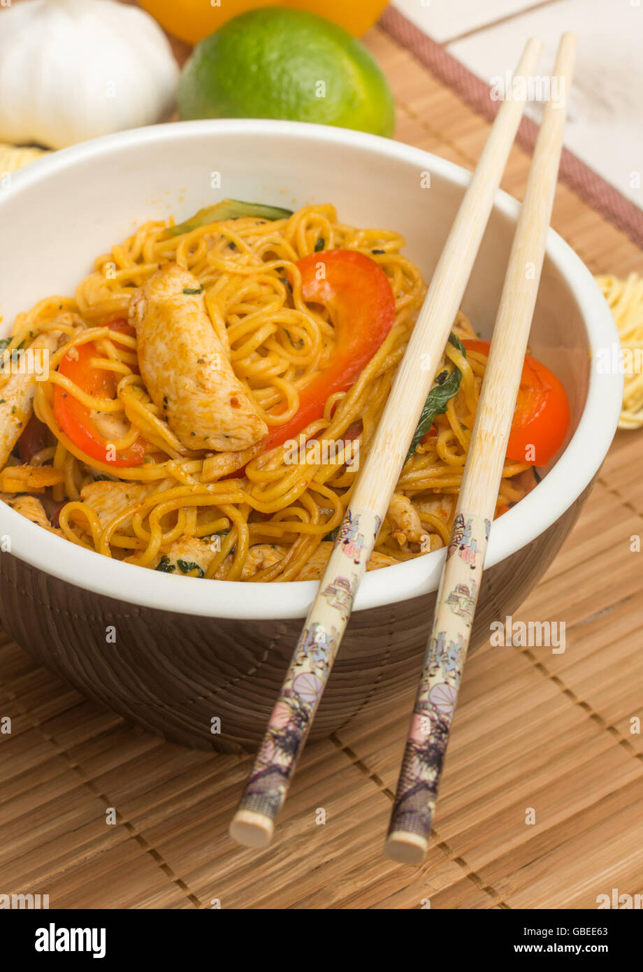 Chinese chow mein with chicken, red peppers and bok choy Stock Photo