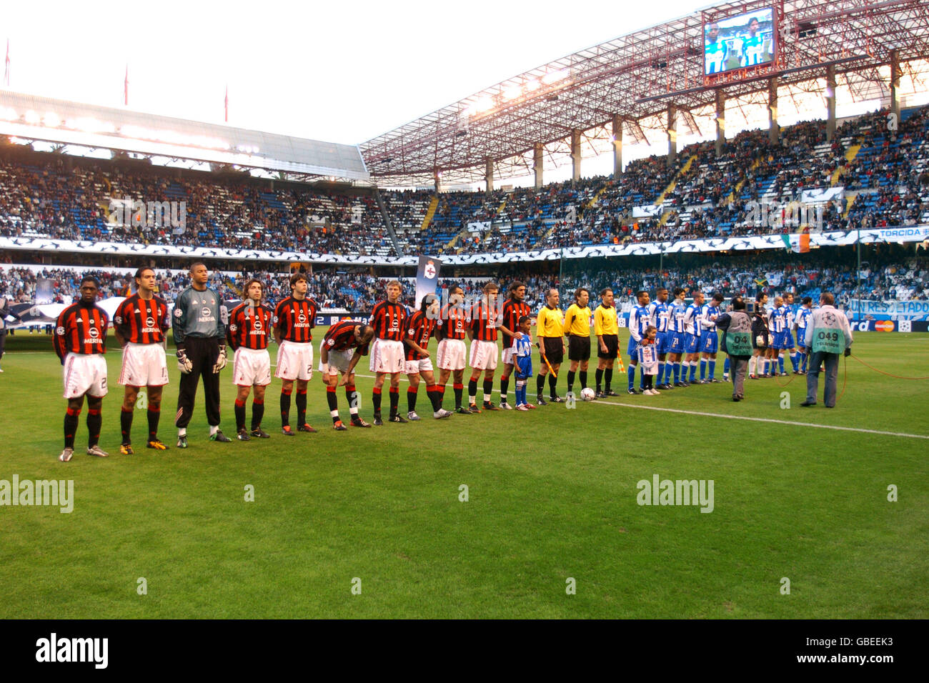 Deportivo La Coruna's and AC Milan's players line up prior to kick off Stock Photo