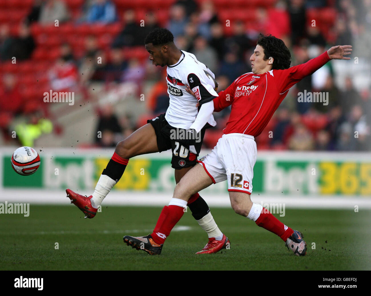 Barnsley's Andranik Teymourian and Charlton Athletic's Therry Racon (left) battle for the ball during the Coca-Cola Championship match at Oakwell, Barnsley. Stock Photo