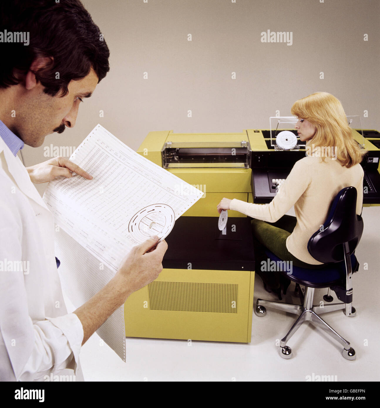 office, young woman at a computer, man in the foreground holding paper, 1960s, Additional-Rights-Clearences-Not Available Stock Photo