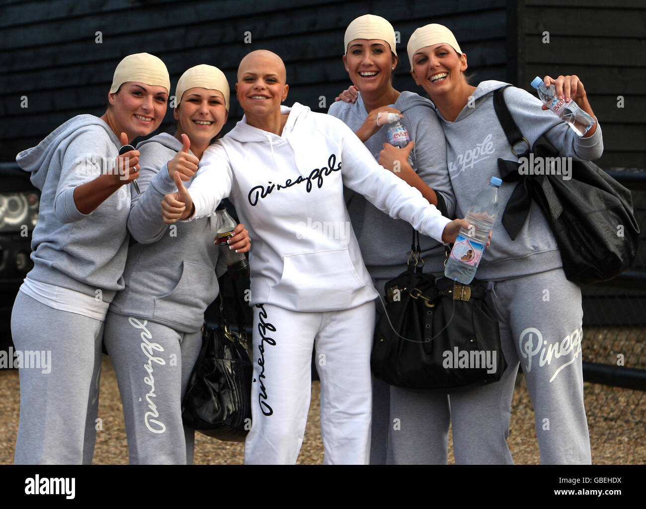 Reality television star Jade Goody poses with friends wearing joke skull caps outside her Essex home on the day before her wedding to fiance Jack Tweed. Stock Photo