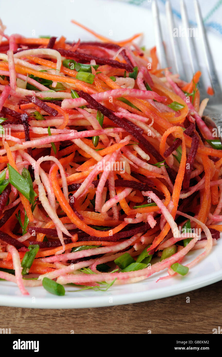 plate salad of shredded raw beets, and carrots  on celery root  close-up Stock Photo