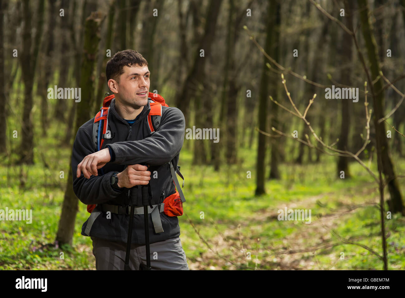 Close up view of back tourist woman brown backpack and fishing rod wearing  on green tourism jacket and walking along the path to the mountains on a  Stock Photo - Alamy