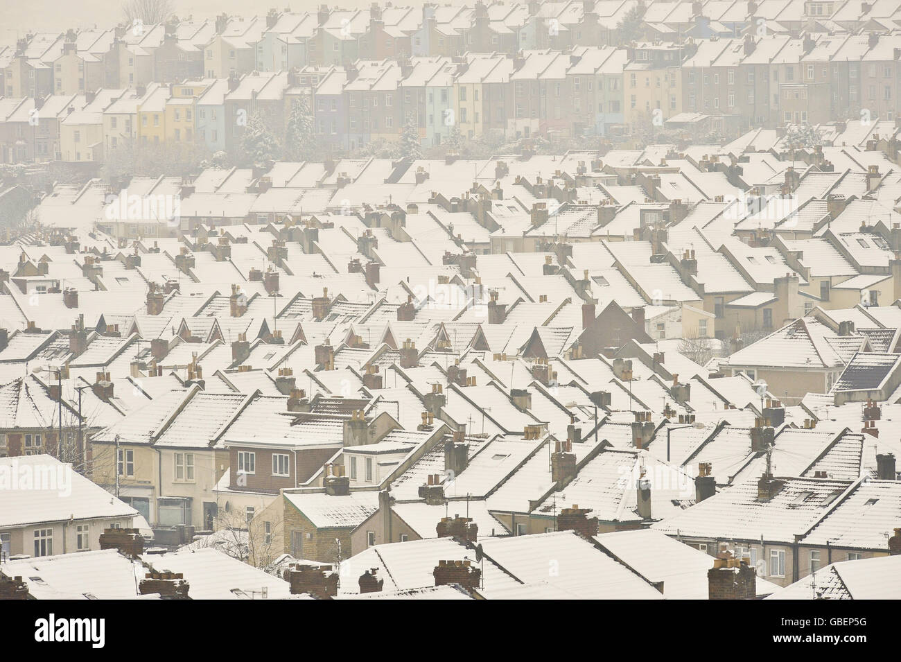 General view of snow lying on top a hundreds of Terraced and semi-detached houses Stock Photo