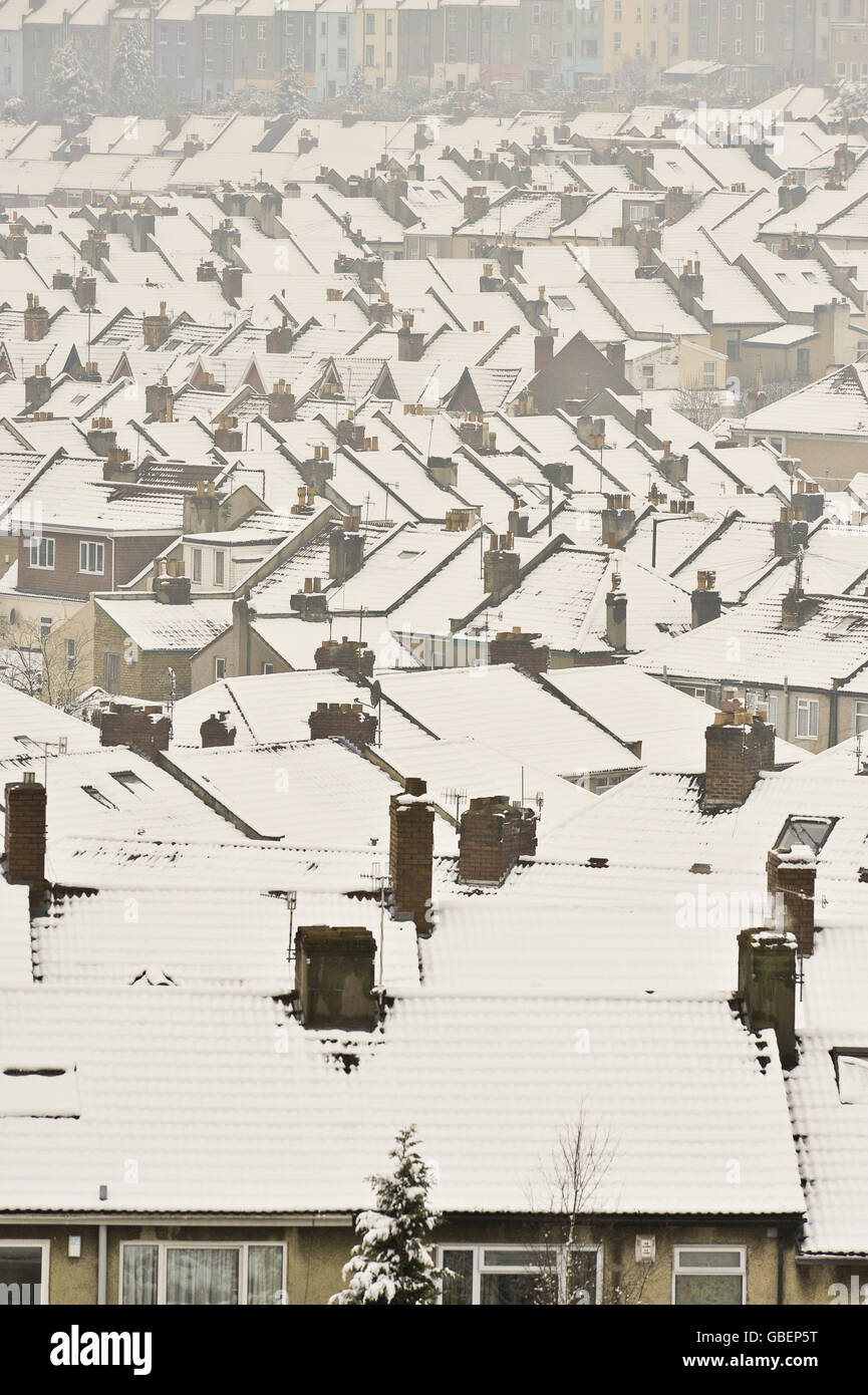 General Stock - Snow Covered Rooftops. General view of snow lying on top a hundreds of Terraced and semi-detached houses Stock Photo