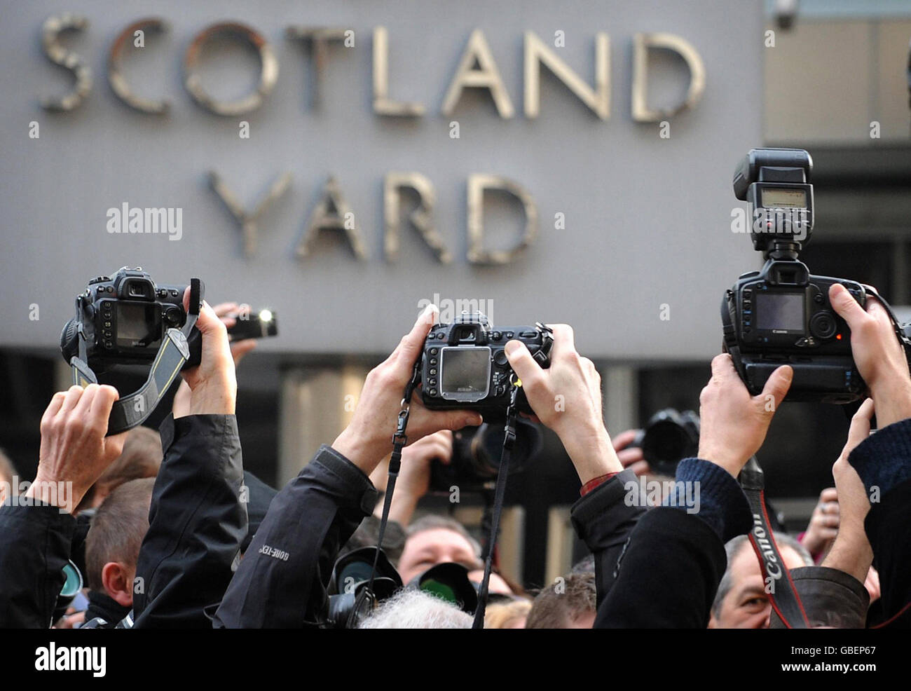 Photographers outside New Scotland Yard in London today protesting at a new anti-terror law. Photojournalists say Section 76 of the Counter Terrorism Act, which became law today, could see them arrested for doing their job. Stock Photo