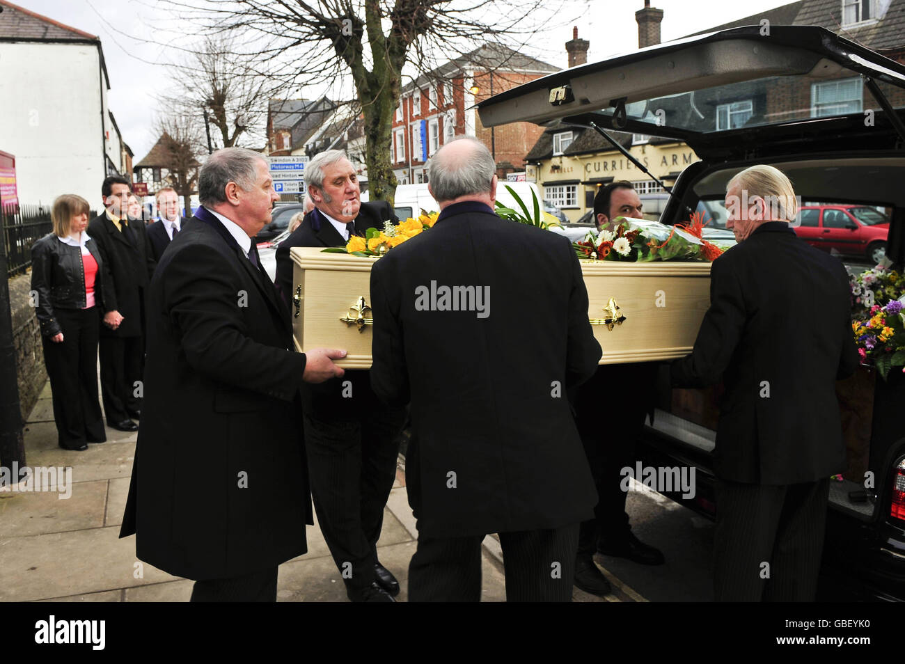 Funeral directors lift the coffin of Hannah Fisher outside St Bartholomew's and All Saints Church, Wootton Bassett, Wiltshire. Stock Photo