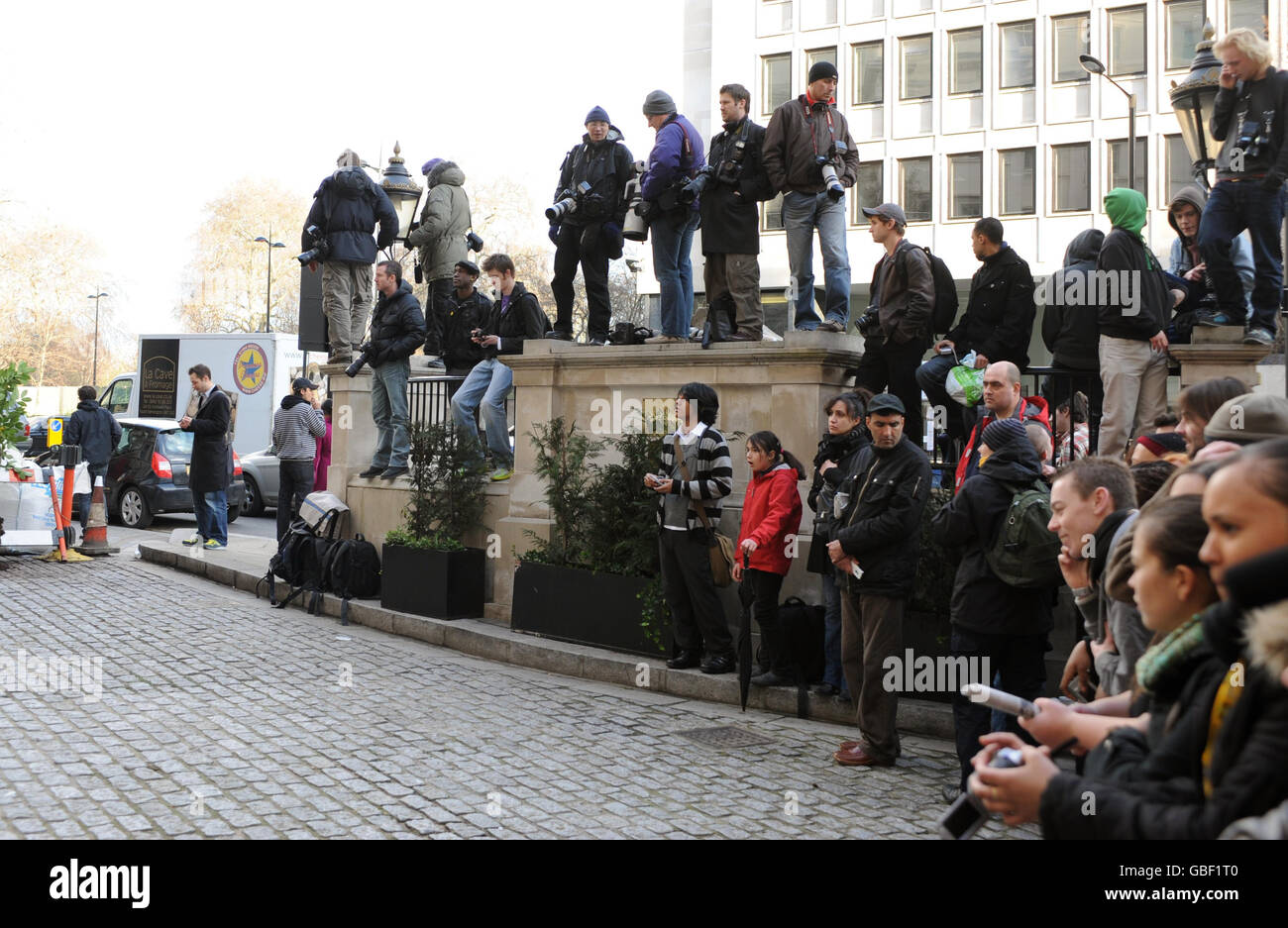 Fans and members of the media wait outside the Lanesborough Hotel in central London where pop star Michael Jackson is rumoured to be staying. Stock Photo