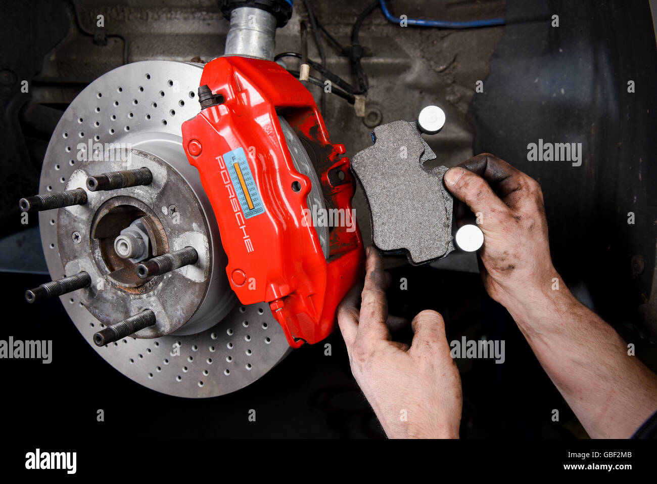Performance brake pads being fitted on Porsche Stock Photo - Alamy