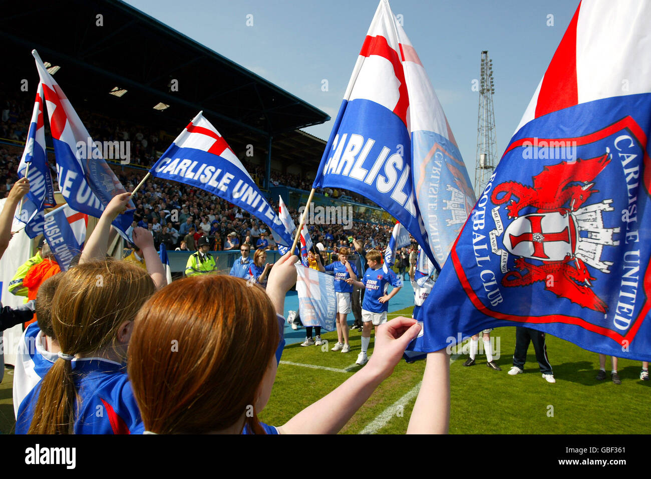 Carlisle United flags are waved as the teams come onto the pitch Stock Photo