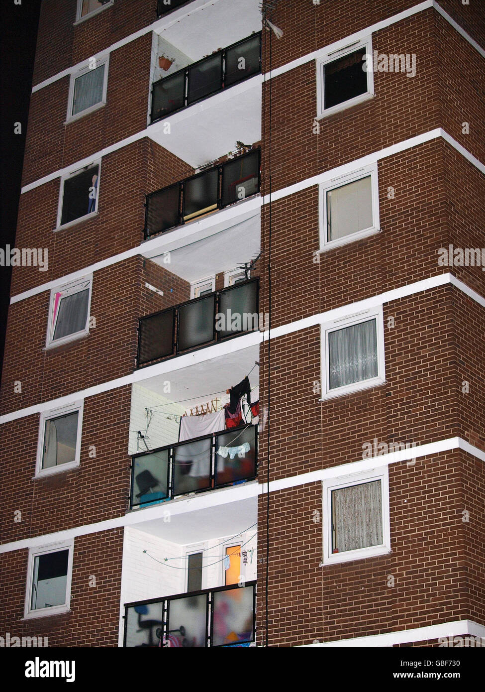 View of the apartment with its blackened windows where a woman and a teenage girl were killed in a suspicious fire in their fifth floor apartment (left) on Cyprus Street, London E2. Stock Photo