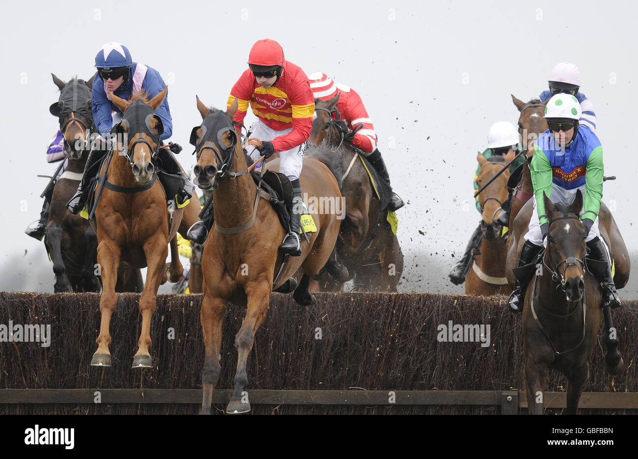 New Little Bric ridden by Nick Scholfield (left) takes the water jump before coming from behind to win The totspot.com Gold Cup Handicap Chase during totesport.com Gold Cup Day at Newbury Racecourse, Newbury. Stock Photo