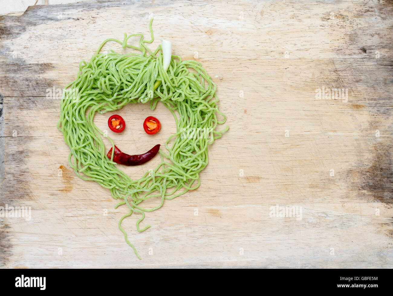 smiley face on wood made from vegetable and noodle Stock Photo