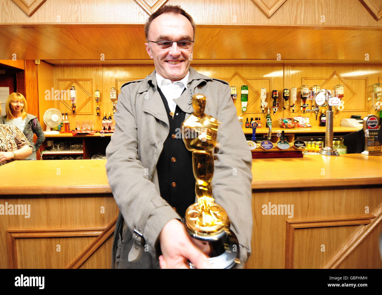 Director Danny Boyle holds his Oscars for Best Director at St Mary's Catholic Social Club in Radliffe near Manchester. Stock Photo
