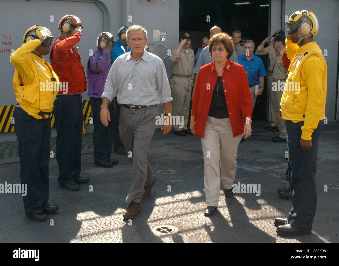 U.S. President George W. Bush and Louisiana Gov. Kathleen Blanco are saluted as they pass through sideboys on the flight deck aboard the amphibious assault ship USS Iwo Jima September 12, 2005 in New Orleans, Louisiana. Bush and Blanco visited the Iwo Jima to be briefed on the status of Joint Task Force Hurricane Katrina relief efforts. Stock Photo