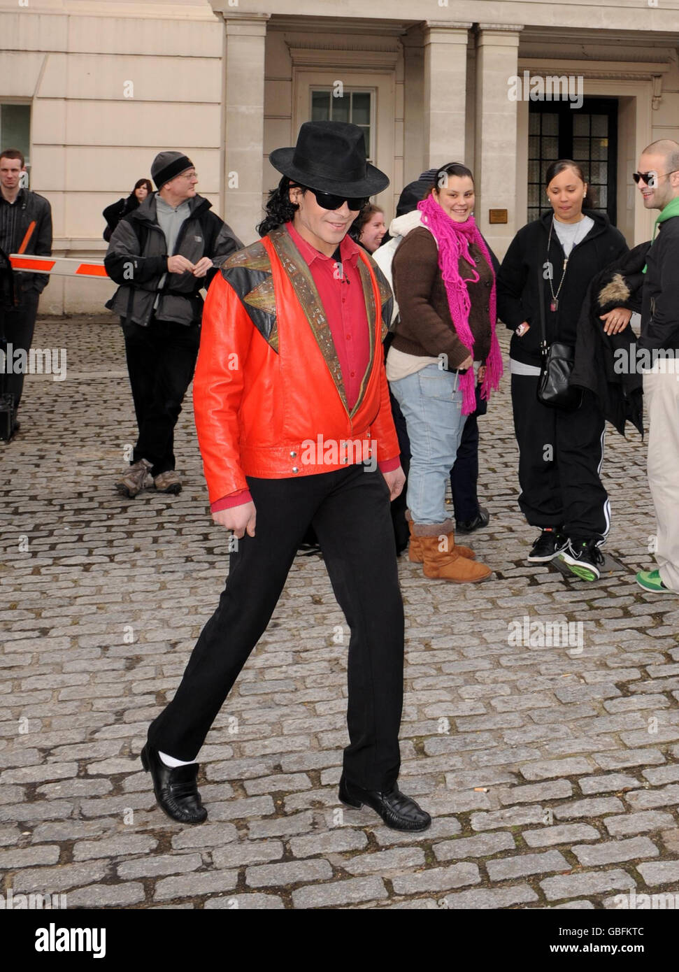 A Michael Jackson look-a-like entertains waiting fans outside the Lanesborough Hotel in central London where pop star Michael Jackson is rumoured to be staying. Stock Photo