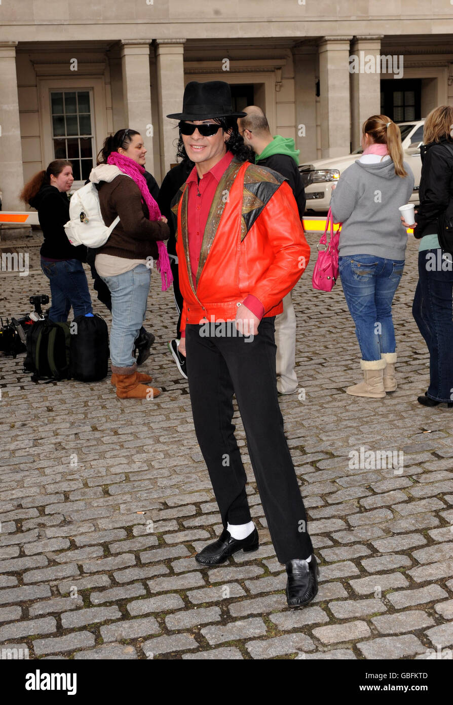 A Michael Jackson look-a-like entertains waiting fans outside the Lanesborough Hotel in central London where pop star Michael Jackson is rumoured to be staying. Stock Photo