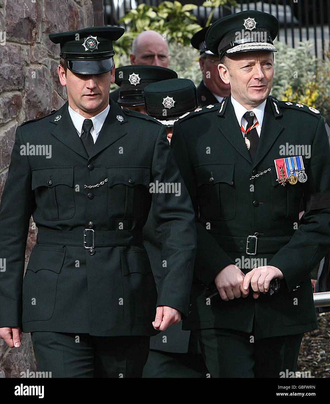 Chief Constable Sir Hugh Orde (right) arrives at St Therese's Church in