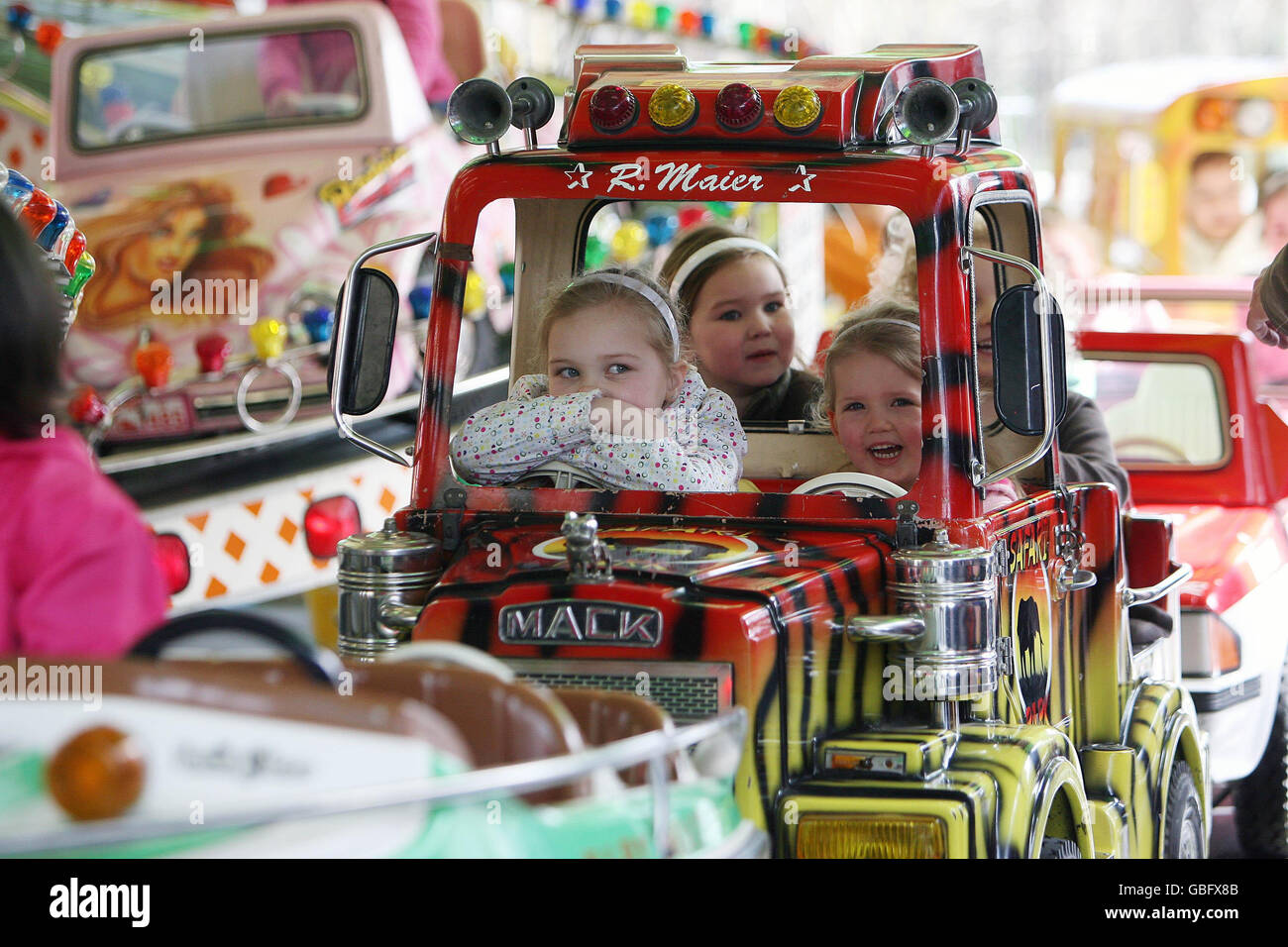 Children on a funfair ride in Dublin's Merrion Square. The Funfair is part of the ongoing St. Patrick's festival which runs until March 17. Stock Photo