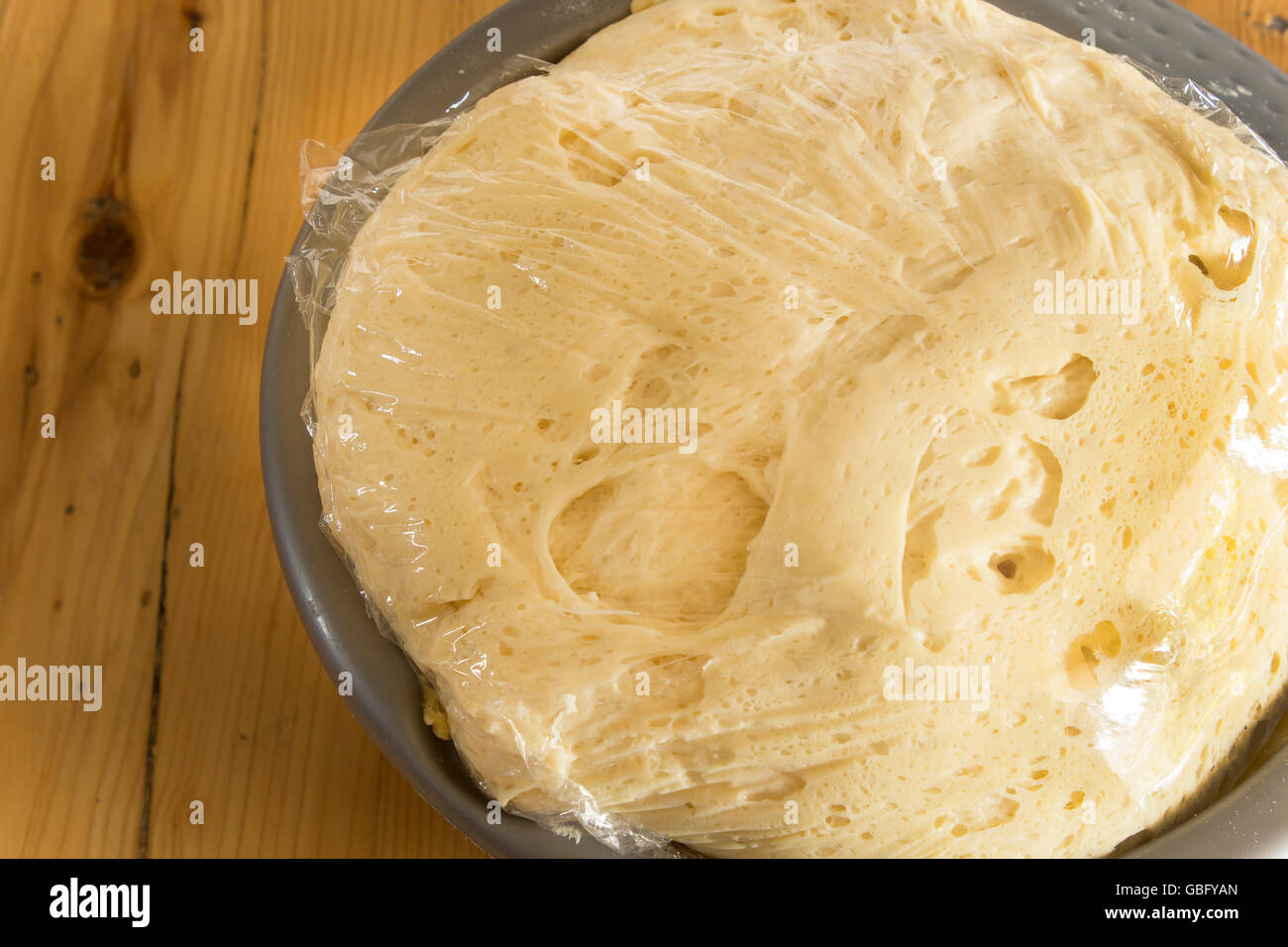 Dough which Grows Under the Foil. Stock Photo