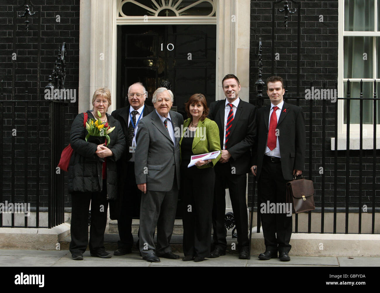 Members of the Haemophilia Society (left to right) Sue Threakall, MP for Knowsley South; Eddie O'Hara, Patron of the Haemophilia Society; Lord Morris of Manchester; the Society Chair, Liz Rizzuto; Chief Executive Chris James and Trustee Matt Gregory deliver a copy of the Archer report into contaminated blood to Ten Downing Street, Westminster, London. Stock Photo