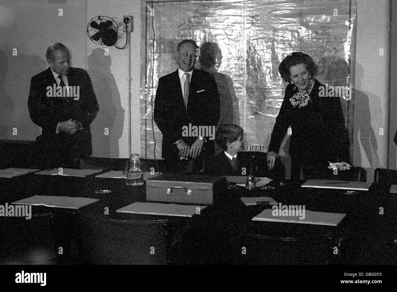 Winston Churchill's underground Second World War bunker which was officially opened to the public for the first time today by Prime Minister Margaret Thatcher. With her in this picture, Churchill's MP grandson Mr Winston Churchill (centre) and his eight year old son Jack Churchill, who sat on the wooden chair in which Britain's then Premier had met with his cabinet more than 100 times. Stock Photo