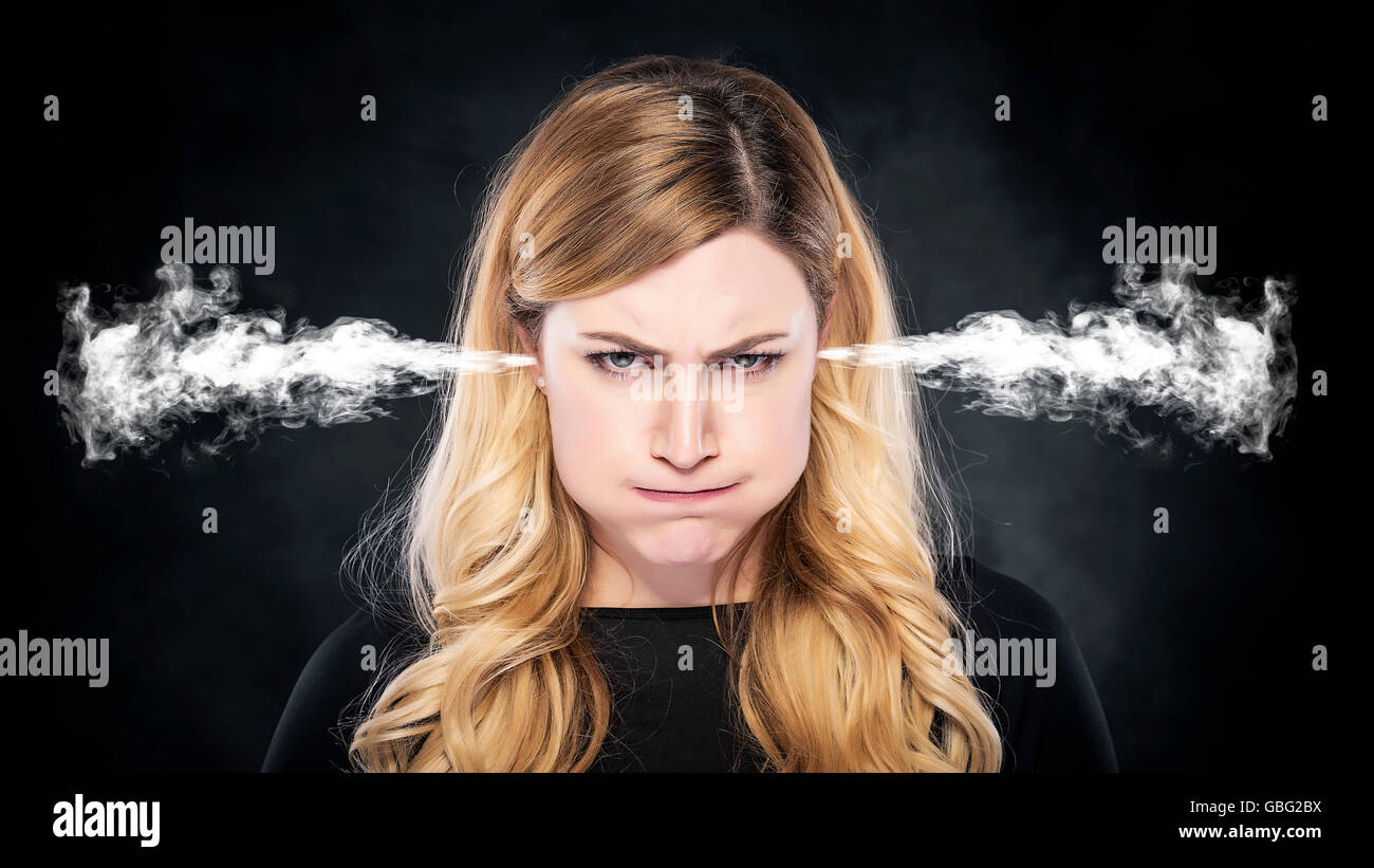 Steam or smoke from the ears of the woman over dark background Stock ...